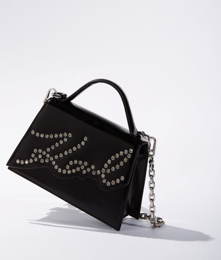 Black handbag with rhinestone details on a white background
